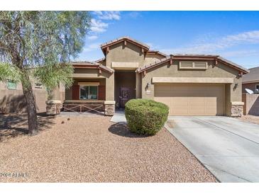 One-story house with a two-car garage and desert landscaping at 23770 W Atlanta Ave, Buckeye, AZ 85326