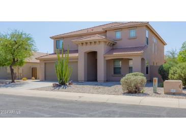 Two-story home with desert landscaping and a two-car garage at 1553 E Bowman Dr, Casa Grande, AZ 85122