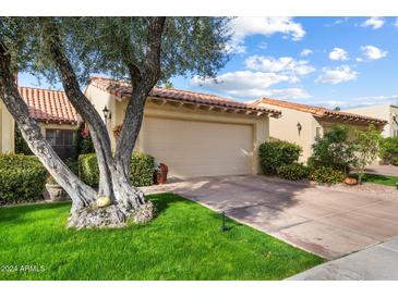 Spanish style home with attached garage and mature landscaping at 10050 E Mountainview Lake Dr # 69, Scottsdale, AZ 85258