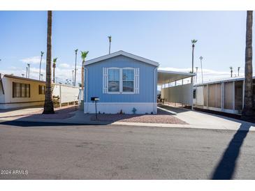 Charming light blue manufactured home with covered carport at 2601 E Allred Ave # Br24, Mesa, AZ 85204