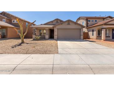 Single-story house with a two-car garage and desert landscaping at 7221 W Globe Ave, Phoenix, AZ 85043