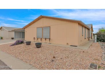 Tan single-story home with landscaping at 437 E Germann Rd # 146, San Tan Valley, AZ 85140