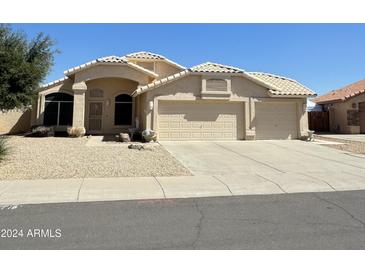 Beautiful two-story home with a three-car garage and desert landscaping at 20411 N 99Th Dr, Peoria, AZ 85382