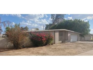 Mid-century modern home with attached garage at 5937 W Coolidge St, Phoenix, AZ 85033
