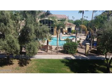 Community pool with surrounding lounge chairs and landscaping at 18416 N Cave Creek Rd # 3060, Phoenix, AZ 85032