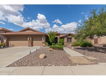 Two-story home with a three-car garage and desert landscaping at 9576 W Blue Sky Dr, Peoria, AZ 85383