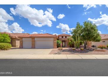 Stunning curb appeal with a two-car garage and desert landscaping at 17621 N Eagle Crest Dr, Surprise, AZ 85374
