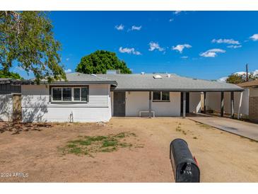 Ranch-style home with a carport and well-maintained yard at 4628 E Holly St, Phoenix, AZ 85008