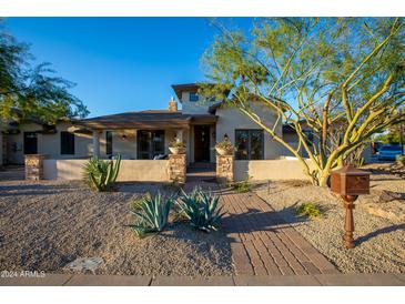 Stunning desert home with a welcoming walkway and mature landscaping at 10050 N 58Th Pl, Paradise Valley, AZ 85253