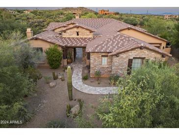 Luxury home with stone exterior and desert landscaping at 10904 E Scopa Trl, Scottsdale, AZ 85262