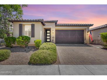Single story home with a two car garage and landscaped yard at 4707 S Avitus Ln, Mesa, AZ 85212