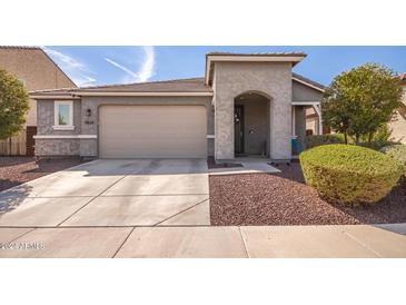 Modern home's exterior with a two-car garage and landscaping at 7824 S 33Rd Ln, Laveen, AZ 85339