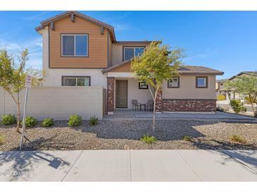 Two-story home with brick and siding exterior, landscaping, and a two-car garage at 10763 W Beatrice St, Avondale, AZ 85323