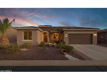 Charming single-story home with a two-car garage and landscaped front yard at 42201 W Rummy Rd, Maricopa, AZ 85138