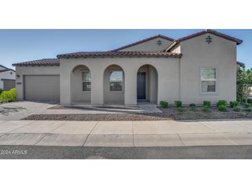 Modern home exterior with arched entryway at 17279 W Dartmouth St, Surprise, AZ 85388