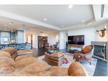 Spacious living room with leather furniture and fireplace at 2211 E Camelback Rd # 505, Phoenix, AZ 85016