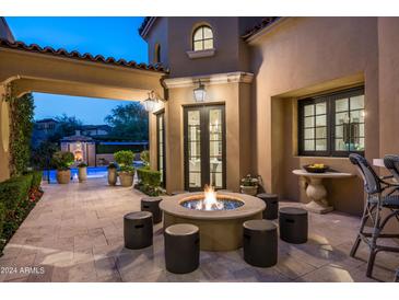 Backyard patio with fire pit and pool view at 9848 E Parkside Ln, Scottsdale, AZ 85255