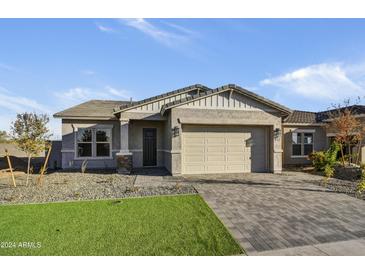 Single-story home with a two-car garage and landscaped front yard at 19366 W San Juan Ave, Litchfield Park, AZ 85340