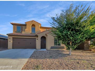 Two-story house with brown accents and a landscaped yard at 2199 E Gillcrest Rd, Gilbert, AZ 85298