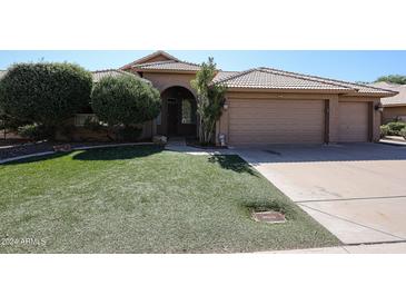 Two-story house with a three-car garage and well-maintained lawn at 4143 E Rockledge Rd, Phoenix, AZ 85044