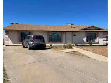 Ranch-style house with a driveway and a spacious yard at 1618 N 52Nd Dr, Phoenix, AZ 85035