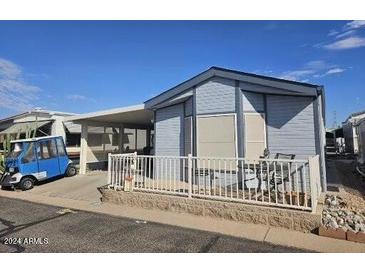 Mobile home with carport and fenced yard at 8700 E University Dr # 1322, Mesa, AZ 85207