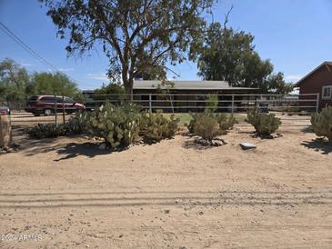 Ranch style home with a large front yard and cactus plants at 26415 S Recker Rd, Queen Creek, AZ 85142