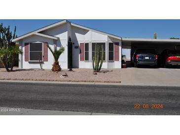Single-wide manufactured home with carport and desert landscaping at 8500 E Southern Ave # 586, Mesa, AZ 85209