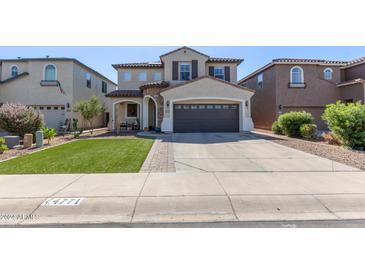 Two-story house with a large brown garage door at 4771 E Meadow Land Dr, San Tan Valley, AZ 85140