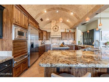 Gourmet kitchen with granite countertops and wood cabinetry at 15512 E Desert Hawk Trl, Fountain Hills, AZ 85268