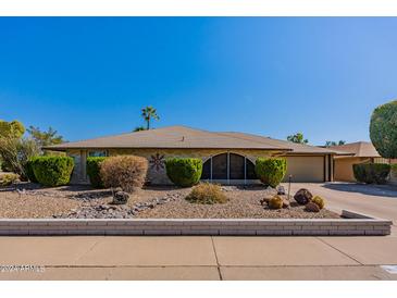 House exterior featuring a well-maintained lawn and landscaping at 18031 N Buntline Dr, Sun City West, AZ 85375