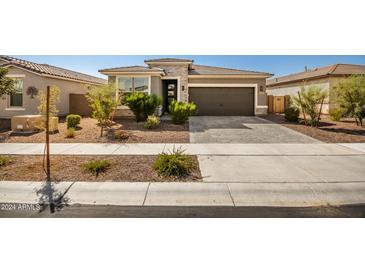 Modern single story home with two car garage and well manicured landscaping at 17657 W Buckhorn Trl, Surprise, AZ 85387