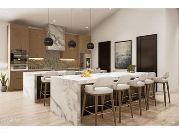 Modern kitchen with large island and marble countertops at 2136 E Paradise Ln, Phoenix, AZ 85022