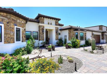 Stunning home exterior with stone accents and landscaped yard at 4455 E Quail Brush Rd, Cave Creek, AZ 85331