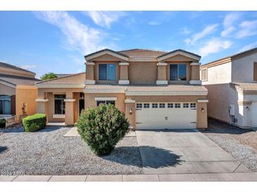 Two-story house with a two-car garage and landscaped yard at 8312 W Pioneer St, Tolleson, AZ 85353