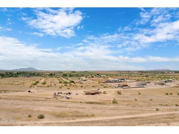 Aerial view of a rural area with various houses and open land at 10784 E Angus Ln, Coolidge, AZ 85128