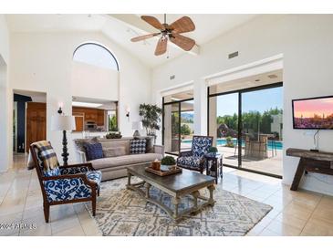 Spacious living room with high ceilings, sliding doors to the pool area, and a view at 8565 E Vista Del Lago N --, Scottsdale, AZ 85255