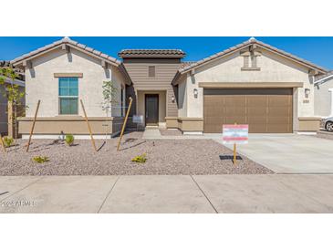 New construction home exterior with two-car garage at 21048 E Arroyo Verde Dr, Queen Creek, AZ 85142