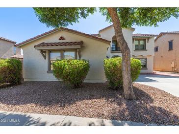 Two-story home with Spanish style architecture and landscaping at 18337 W Stinson Dr, Surprise, AZ 85374