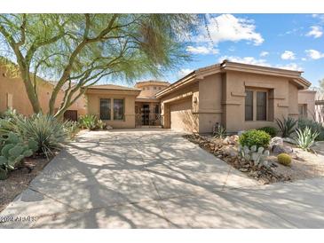 Front view of a two-story house with a large driveway at 7473 E Soaring Eagle Way, Scottsdale, AZ 85266