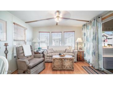 Living room with wicker coffee table and comfy armchairs at 312 S Emerald Dr, Apache Junction, AZ 85119