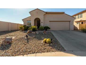 Tan house with arched entryway and two-car garage at 19104 N Smith Dr, Maricopa, AZ 85139