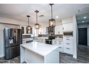 Modern kitchen with stainless steel appliances and an island at 2501 E Campbell Ave, Phoenix, AZ 85016