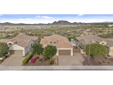 Aerial view of a house with desert landscape and mountains in the background at 7450 W Paso Trl, Peoria, AZ 85383