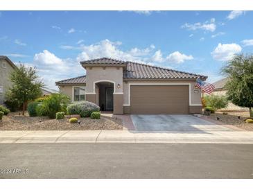 Single-story home with a two-car garage and desert landscaping at 26803 W Firehawk Dr, Buckeye, AZ 85396