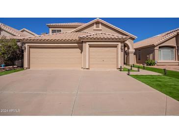 Two-car garage and attractive landscaping at 192 W Los Arboles Dr, Tempe, AZ 85284