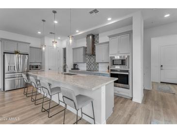 Modern kitchen with large island, gray cabinets, and stainless steel appliances at 1524 E Dublin St, Gilbert, AZ 85295