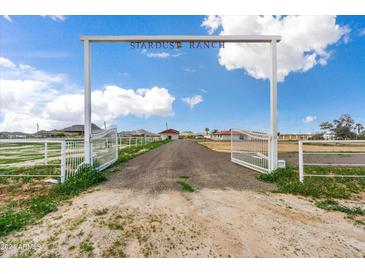 Stardust Ranch entrance with open gates at 14700 S Tuthill Rd, Buckeye, AZ 85326
