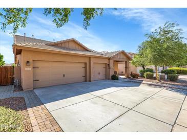 Two-car garage and front entry of tan house at 21527 N 78Th Ln, Peoria, AZ 85382