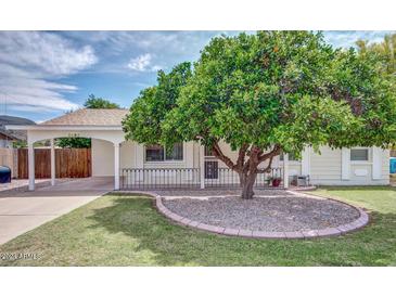 Charming ranch home with covered porch and mature landscaping at 2035 W Eugie Ave, Phoenix, AZ 85029